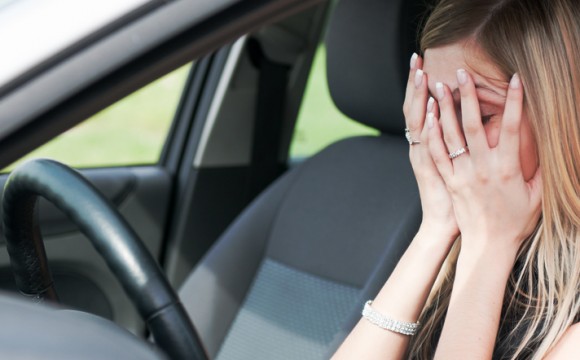 Troubles - unhappy woman in car