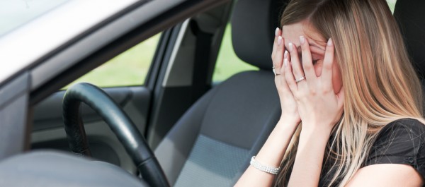 Troubles - unhappy woman in car